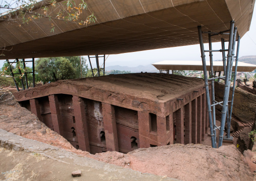 Protective shelters over a monolithic rock-cut church, Amhara region, Lalibela, Ethiopia