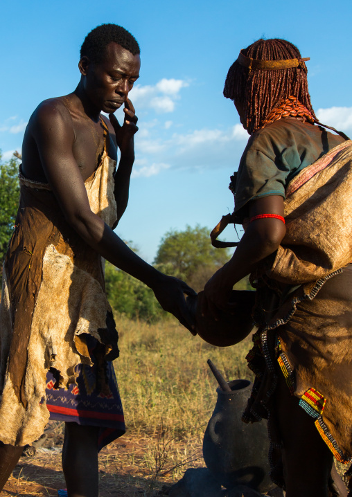 Hamer tribe jumper taking some drink before the bull jumping l, Omo valley, Turmi, Ethiopia