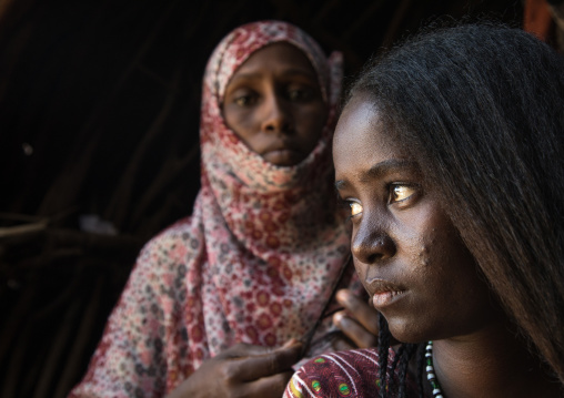 Afar woman having a traditional hairstyle inside her hut, Afar region, Afambo, Ethiopia