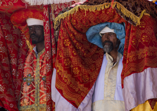 Ethiopian priests carrying some covered tabots on their heads during Timkat epiphany festival, Amhara region, Lalibela, Ethiopia