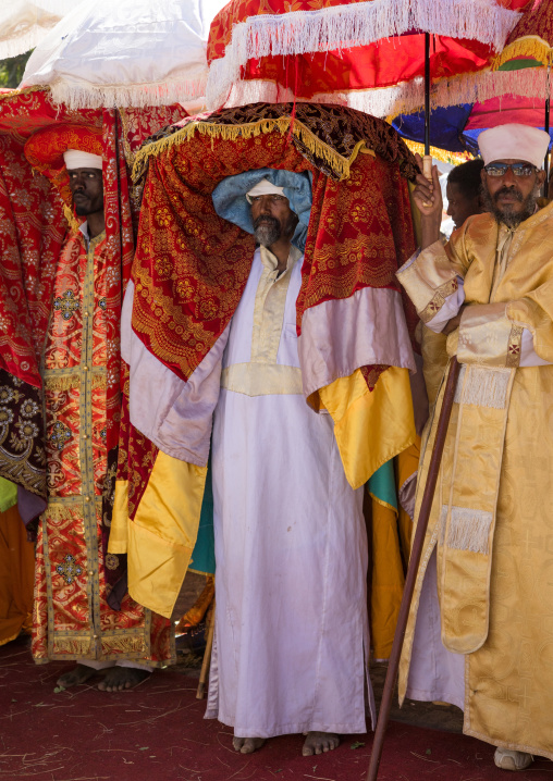 Ethiopian priests carrying some covered tabots on their heads during Timkat epiphany festival, Amhara region, Lalibela, Ethiopia