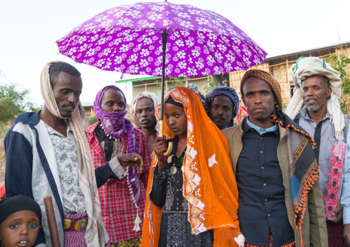 Oromo woman veiled during her wedding celebration with her husband and relatives, Amhara region, Artuma, Ethiopia