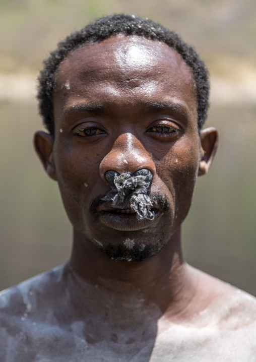 Borana tribe man with protection in his nose ready to dive in the volcano crater to collect salt, Oromia, El Sod, Ethiopia