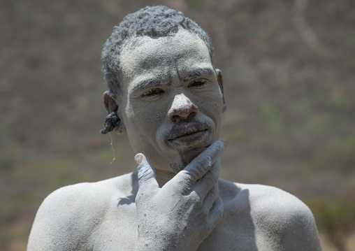 Borana tribe man covered with salt after diving in the volcano crater to collect salt, Oromia, El Sod, Ethiopia