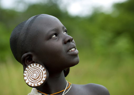 Surma girl watching a donga session, Tulgit, Omo valley, Ethiopia