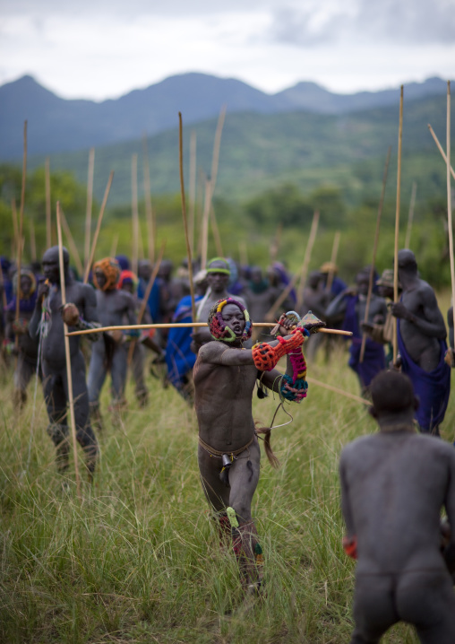 Suri tribe warriors fighting during a donga stick ritual, Omo valley, Tulgit, Ethiopia