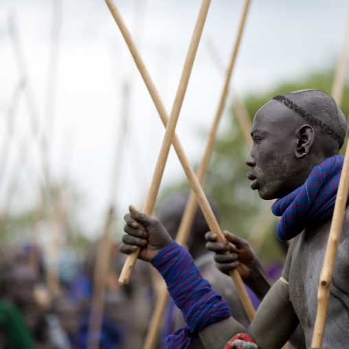 Suri tribe warriors fighting during a donga stick ritual, Omo valley, Tulgit, Ethiopia