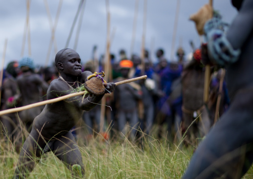 Suri tribe warriors fighting during a donga stick ritual, Omo valley, Tulgit, Ethiopia