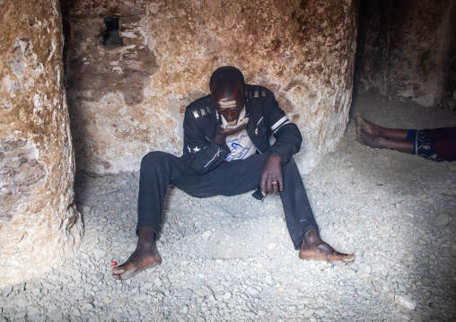 Oromo pilgrim in Sheikh Hussein shrine eating jarawa powder to cure himself, Oromia, Sheik Hussein, Ethiopia