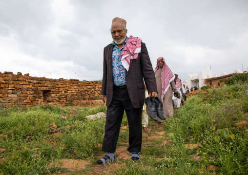 Oromo pilgrims men walking in line in the shrine of sufi Sheikh Hussein , Oromia, Sheik Hussein, Ethiopia