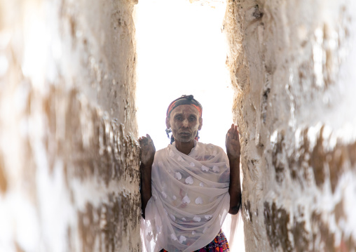 Oromo pilgrim in Sheikh Hussein shrine in a symbolic narrow corridor, Oromia, Sheik Hussein, Ethiopia