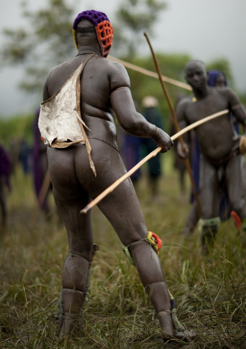 Suri tribe warriors fighting during a donga stick ritual, Omo valley, Tulgit, Ethiopia