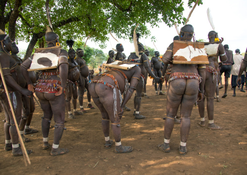 Bodi tribe fat men resting during Kael ceremony, Omo valley, Hana Mursi, Ethiopia