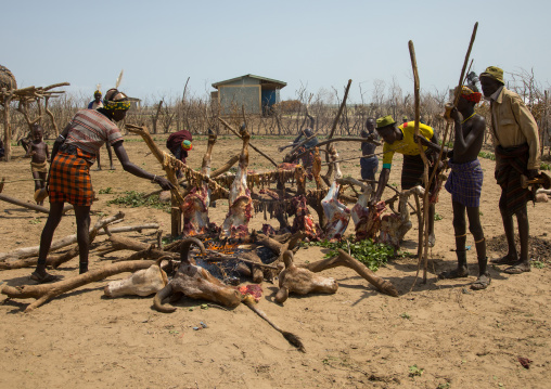 Tribe people cooking a cowduring the proud ox ceremony in the Dassanech tribe, Omo valley, Omorate, Ethiopia