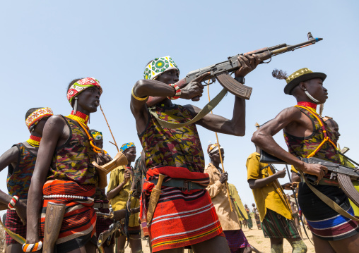 Man shooting with a kalashnikov during the proud ox ceremony in the Dassanech tribe, Turkana County, Omorate, Ethiopia