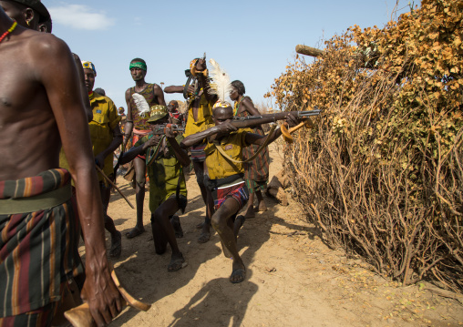 Man shooting with a kalashnikov during the proud ox ceremony in the Dassanech tribe, Turkana County, Omorate, Ethiopia