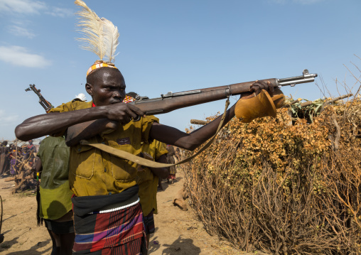 Man shooting with a kalashnikov during the proud ox ceremony in the Dassanech tribe, Turkana County, Omorate, Ethiopia