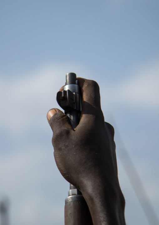 Man holding a kalashnikov during the proud ox ceremony in Dassanech tribe, Turkana County, Omorate, Ethiopia