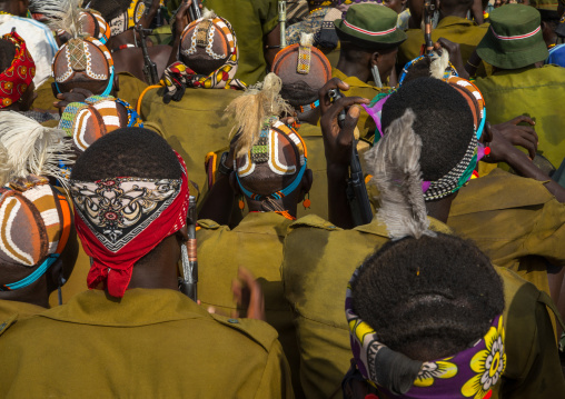 Tribe warriors during the proud ox ceremony in the Dassanech tribe waiting to share the cow meat, Turkana County, Omorate, Ethiopia