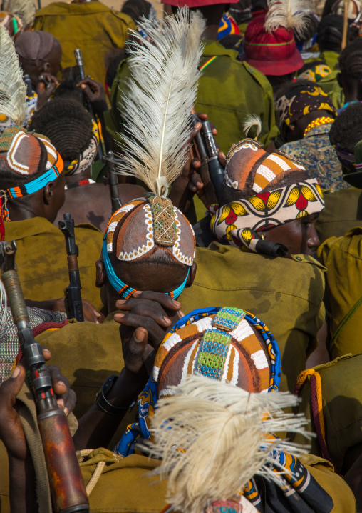 Tribe warriors during the proud ox ceremony in the Dassanech tribe waiting to share the cow meat, Turkana County, Omorate, Ethiopia