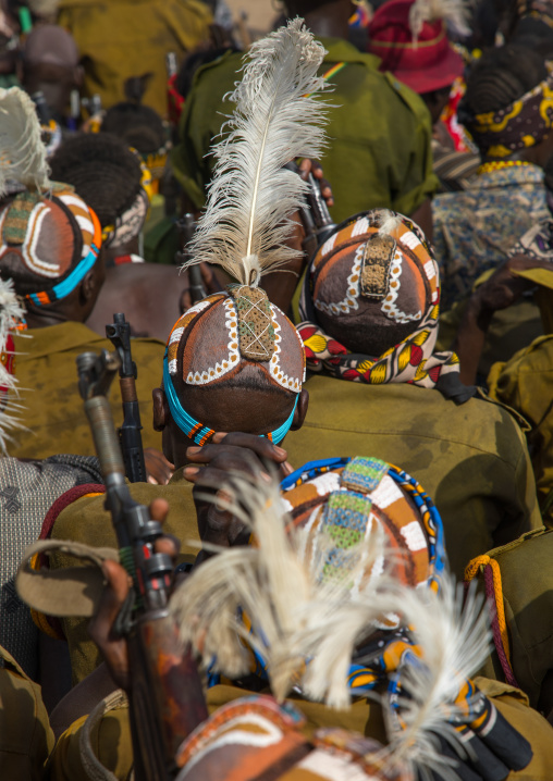 Tribe warriors during the proud ox ceremony in the Dassanech tribe waiting to share the cow meat, Turkana County, Omorate, Ethiopia