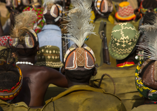 Tribe warriors during the proud ox ceremony in the Dassanech tribe waiting to share the cow meat, Turkana County, Omorate, Ethiopia