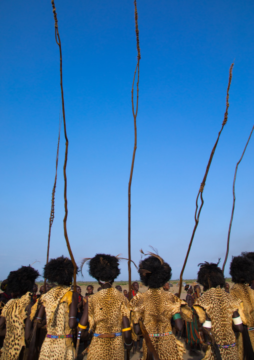 Dassanech men with leopard skins and ostrich feathers wigs during Dimi ceremony to celebrate circumcision of teenagers, Turkana County, Omorate, Ethiopia