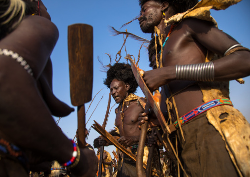 Dassanech men with leopard skins and ostrich feathers wigs during Dimi ceremony to celebrate circumcision of teenagers, Turkana County, Omorate, Ethiopia