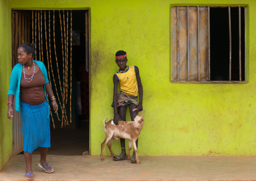 Bana tribe boy with his goat in front of a bar, Omo valley, Key Afer, Ethiopia