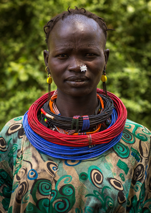 Portrait of a sudanese Toposa tribe woman refugee with huge necklaces and nose decoration, Omo Valley, Kangate, Ethiopia