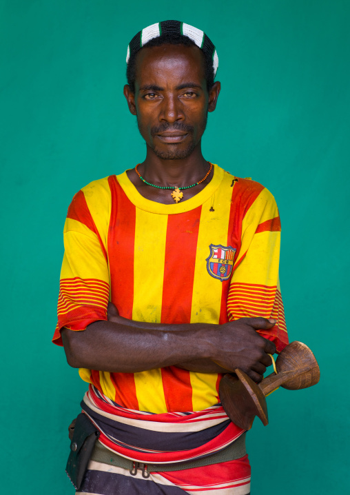 Portrait of a Hamer tribe man wearing a barcelona football shirt, Omo valley, Dimeka, Ethiopia