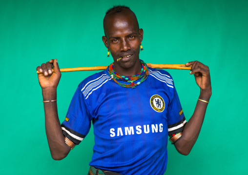 Portrait of a Hamer tribe man wearing a chelsea football shirt, Omo valley, Dimeka, Ethiopia