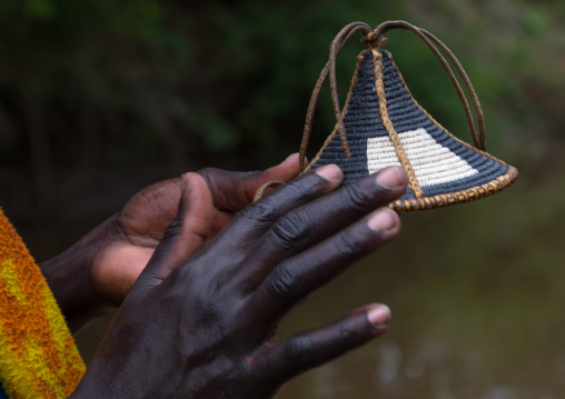 Bodi tribe cleaning his shield before the Kael ceremony, Omo valley, Hana Mursi, Ethiopia