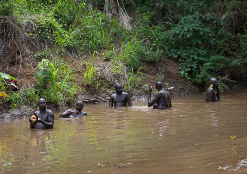 Bodi tribe fat men taking a bath before the Kael ceremony, Omo valley, Hana Mursi, Ethiopia