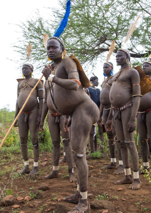 Bodi tribe fat men resting during Kael ceremony, Omo valley, Hana Mursi, Ethiopia