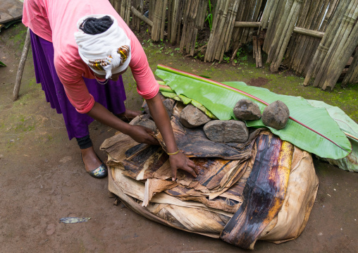 A Dorze woman prepares unleavened bread made from the false banana tree, Gamo Gofa Zone, Gamole, Ethiopia