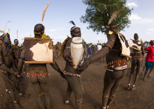 Bodi tribe fat man taking some milk during Kael ceremony, Omo valley, Hana Mursi, Ethiopia