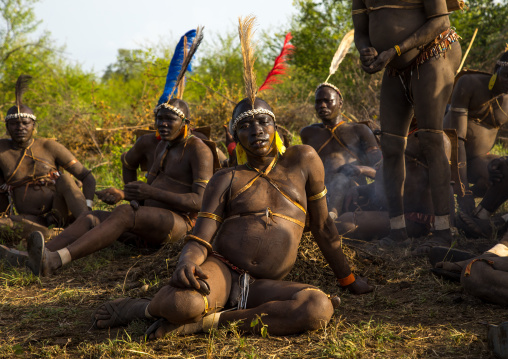 Bodi tribe fat men resting during Kael ceremony, Omo valley, Hana Mursi, Ethiopia