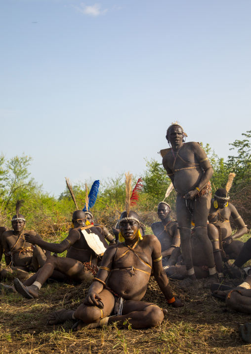 Bodi tribe fat men resting during Kael ceremony, Omo valley, Hana Mursi, Ethiopia