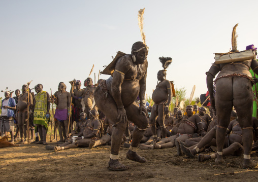 Bodi tribe fat men resting during Kael ceremony, Omo valley, Hana Mursi, Ethiopia