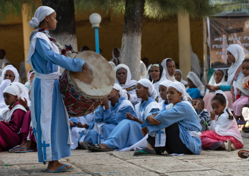 Ethiopian girl playing drum during a mass in an  orthodox church, Harari Region, Harar, Ethiopia