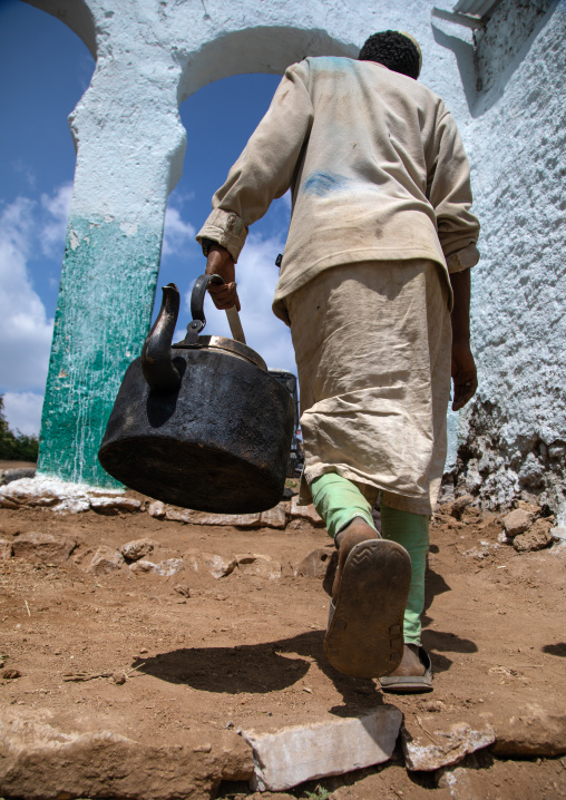 Muslim man holding a huge teapot, Harari Region, Harar, Ethiopia