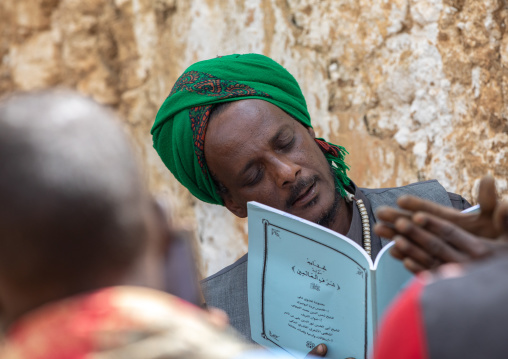 Harari islamic cleric praying during a sufi celebration, Harari Region, Harar, Ethiopia