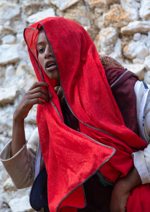 Sufi woman with a red veil into trance during a muslim ceremony, Harari Region, Harar, Ethiopia