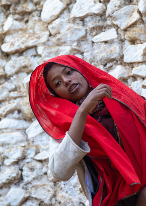 Sufi woman with a red veil into trance during a muslim ceremony, Harari Region, Harar, Ethiopia