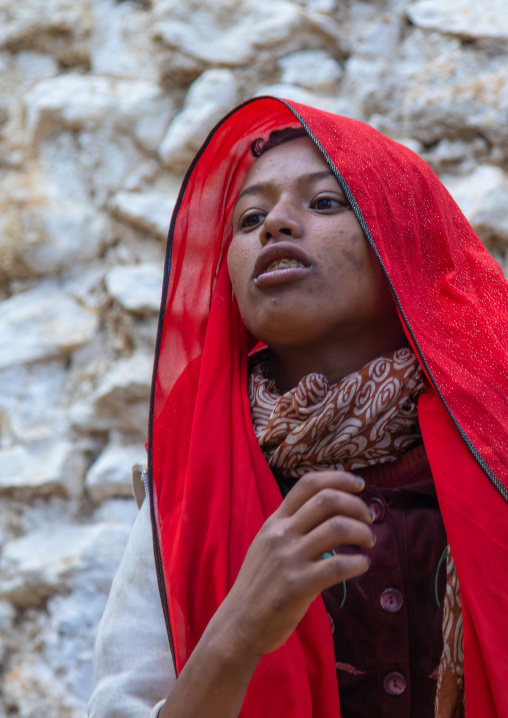 Sufi woman with a red veil into trance during a muslim ceremony, Harari Region, Harar, Ethiopia