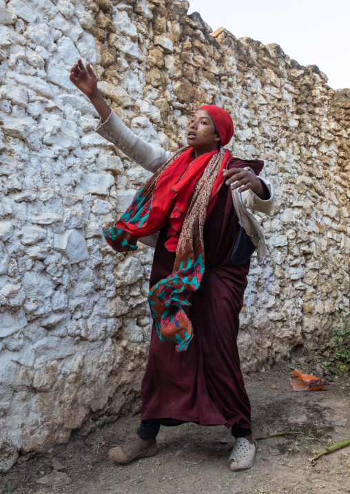 Sufi woman with a red veil into trance during a muslim ceremony, Harari Region, Harar, Ethiopia