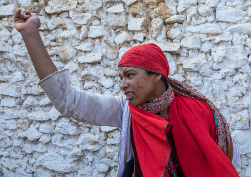 Sufi woman with a red veil into trance during a muslim ceremony, Harari Region, Harar, Ethiopia