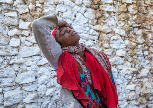 Sufi woman with a red veil into trance during a muslim ceremony, Harari Region, Harar, Ethiopia