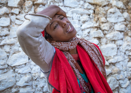 Sufi woman with a red veil into trance during a muslim ceremony, Harari Region, Harar, Ethiopia